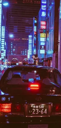 This phone wallpaper showcases a stunning Japan travel aesthetic, featuring a car driving through a bustling city street at night