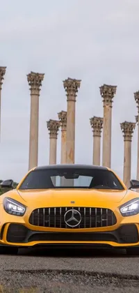 This live wallpaper features a yellow Mercedes sports car speeding down a road, set against a background of marble columns
