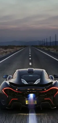 This live wallpaper features a high-quality image of a black sports car driving down a highway