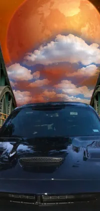 This live wallpaper features a sleek black car parked on a bridge against a stunning landscape inspired by realistic paintings
