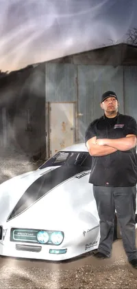 Get revved up with this phone live wallpaper; featuring an impressive image of a man standing beside a white muscle car