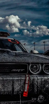 This live wallpaper depicts a close up view of a sharp and aggressive car in a spacious parking lot