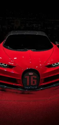 Experience the thrill of a red Bugatti car sitting on top of a luxurious red carpet with this stunning live wallpaper
