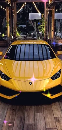 This live wallpaper showcases a bright yellow sports car parked on a wooden floor