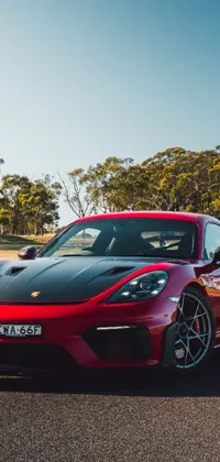Looking for a sleek and stylish wallpaper to jazz up your phone? Look no further than this red and black sports car live wallpaper! With a baroque styled background, 4k vertical resolution, and a Porsche roaring down the road, this wallpaper is perfect for anyone who loves edgy and bold designs