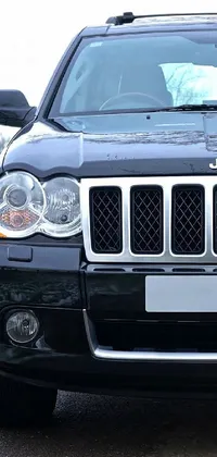 This phone live wallpaper depicts a silver Jeep parked beside a rural road with its headlights on
