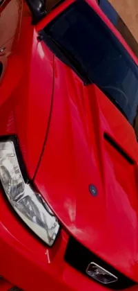 Get ready to rev things up with this hyper-realistic phone live wallpaper! Featuring a stunning red sports car parked in a spacious garage, this close-up shot is brimming with intricate photorealistic textures, shadows, and lighting