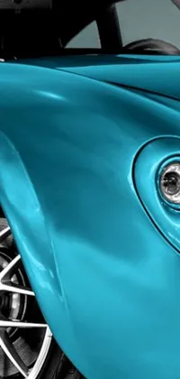 This wallpaper showcases a close-up view of a stunning blue sports car that features intricate details, bright turquoise color, and a professional paint job