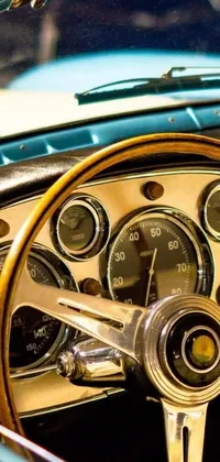 This mobile live wallpaper features a close-up shot of a classic car's steering wheel