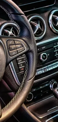 This phone live wallpaper depicts a close-up view of a car steering wheel