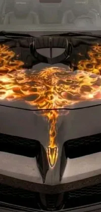 This phone live wallpaper features a fiery car design, with flames on the hood and a bat head with golden wings of flame