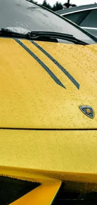 This live phone wallpaper depicts a sporty yellow car parked in a lot