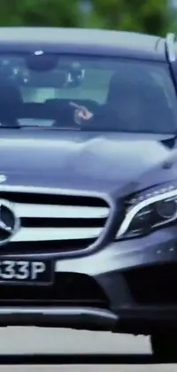 This live wallpaper for your phone features a clear close-up view of a fast-moving Mercedes car driving on a road