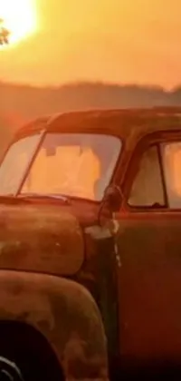 This stunning phone live wallpaper features an old truck against a beautiful sunset background