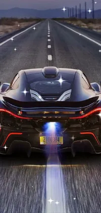 This phone live wallpaper features a stunning black sports car speeding down a road