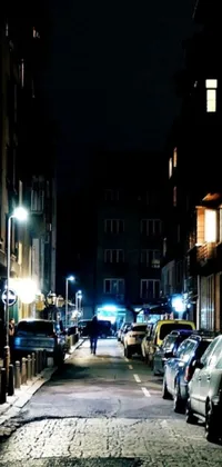 Looking for a captivating live wallpaper for your phone? Check out this stunning image of a person walking down a dimly-lit street at night in the exciting city of Brussels