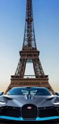 Enjoy a stunning live wallpaper for your mobile phone that showcases a gleaming silver Bugatti parked in front of the majestic Eiffel Tower