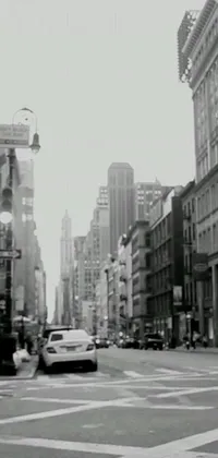 This black and white phone live wallpaper depicts a busy city street with high-rise buildings, cars driving past and white-collar workers bustling about
