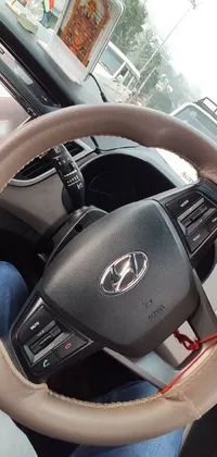 This phone live wallpaper showcases a close-up view of a driver navigating the roads in their car