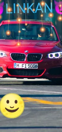 This dynamic live wallpaper on your phone depicts a red car driving on a street with a happy face