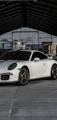 This live wallpaper features a white sports car parked in a dimly lit garage