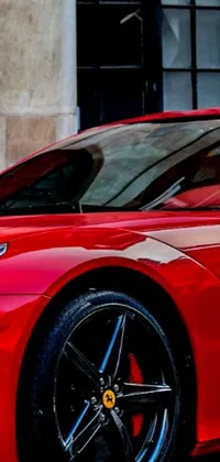 If you're a fan of sports cars, then this phone live wallpaper is perfect for you! The design features a sleek and stylish red vehicle parked in front of a modern building