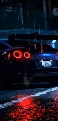 Get yourself some inspiration with this incredible phone live wallpaper featuring a fast Nissan GTR R 3 4 driving down a wet, neon backlit street at night