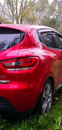 This stunning phone live wallpaper depicts a vibrant red Renault Ultimo car parked atop a lush green field, captured by a GoPro camera