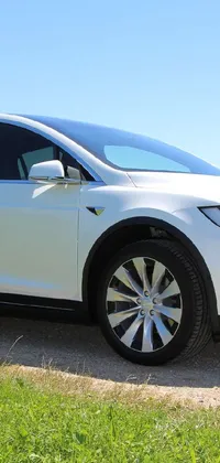 If you&#39;re a car enthusiast looking for a stunning live wallpaper, look no further than this white Tesla SUV parked on a dirt road