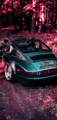 This stunning live wallpaper for your phone features an ultra-realistic painting of a sleek Porsche 911 parked in a forest