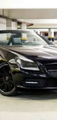 Adorn your phone with the sleekness of a black Mercedes convertible that is beautifully parked in a luxurious parking garage via this live wallpaper