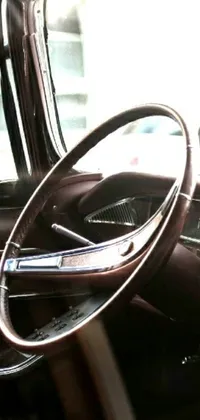 This live wallpaper capture the essence of a vintage car with its striking steering wheel featuring curved horns, photographed with the provia 1967 technique