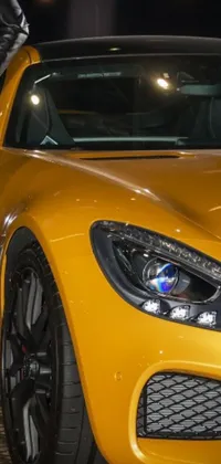 Transform your phone background with this stunning live wallpaper featuring a yellow Mercedes sports car