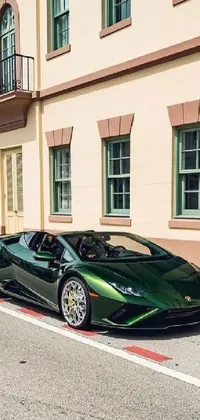 This phone live wallpaper features a green Lamborghini sports car parked in front of an elegant building on an empty, quiet street