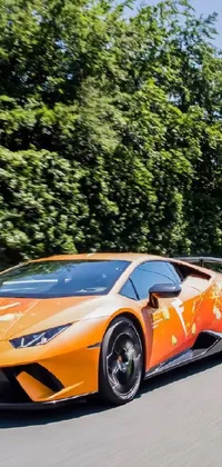 This live wallpaper features an awe-inspiring orange sports car driving down a winding highway