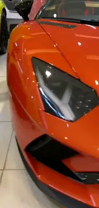 This live wallpaper is a car lover's dream, with a high definition, close-up shot of a red sports car set in a luxurious showroom