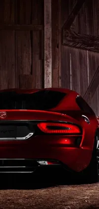 Looking for an adrenaline-filled phone live wallpaper? Look no further! This dynamic wallpaper features a vibrant red sports car parked in front of a rustic barn door