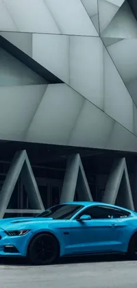 This phone live wallpaper showcases a blue ford mustang parked in front of a modern building