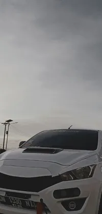 This phone live wallpaper showcases an impressive white car parked alongside a road, with a dramatic sky in the background