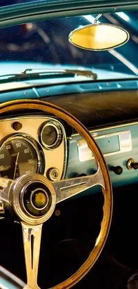 This phone live wallpaper showcases a vintage steering wheel of a car in a hypermodern style