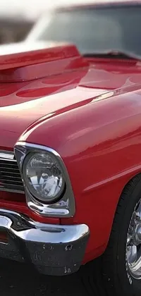 This phone live wallpaper features a breathtaking portrait of a red muscle car parked in a parking lot