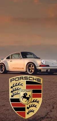 This live wallpaper features two Porsches parked on a beautiful road with a sunset background