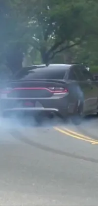 This lively phone wallpaper features a car emitting thick, billowing smoke