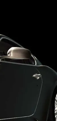 This live wallpaper features a photorealistic close up shot of a black sports car on a black background