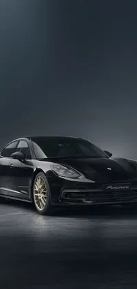 This cool phone live wallpaper showcases a black sports car parked in a dimly lit room