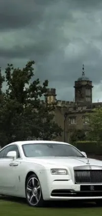 Transform your phone screen with this magnificent live wallpaper featuring a white Rolls Royce parked against the backdrop of a majestic castle