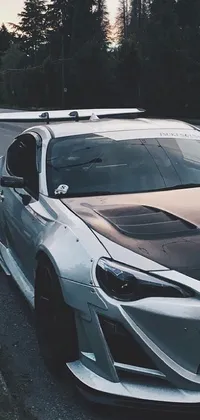 This live wallpaper features a stunning sports car parked on the side of the road