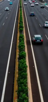 This phone live wallpaper features a bustling highway with an array of cars driving down it