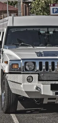 This live phone wallpaper features a luxurious silver Hummer parked on a black and white gauze patterned parking lot