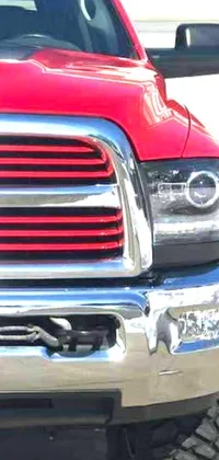 This phone live wallpaper features a striking image of a polished red truck parked in front of a rustic garage
